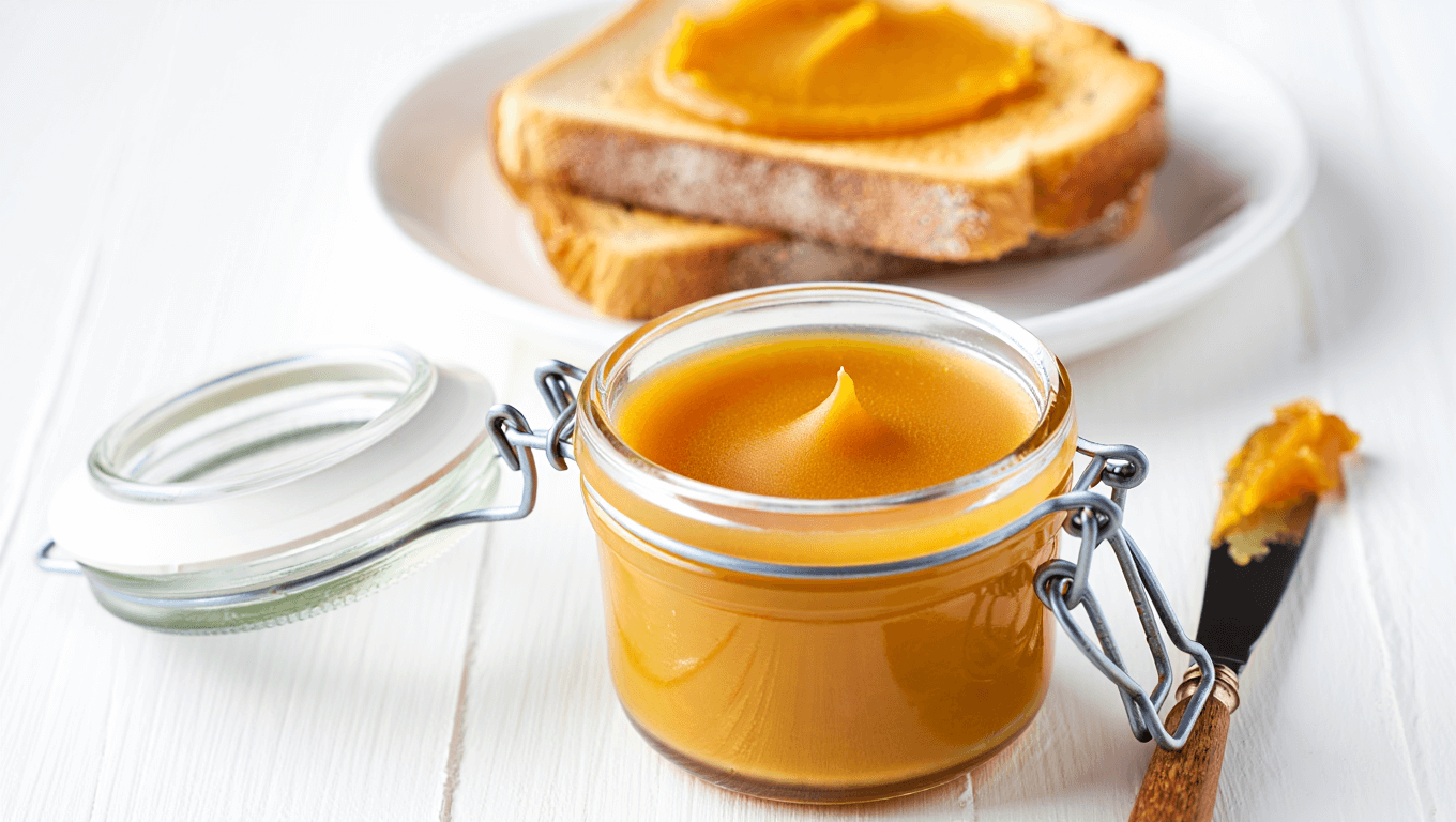honey butter in bowl with gold butter knife.