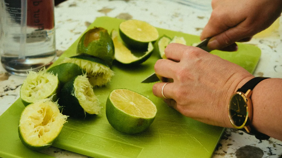 Fresh peaches, lime juice, and tequila ingredients laid out for making a peach margarita