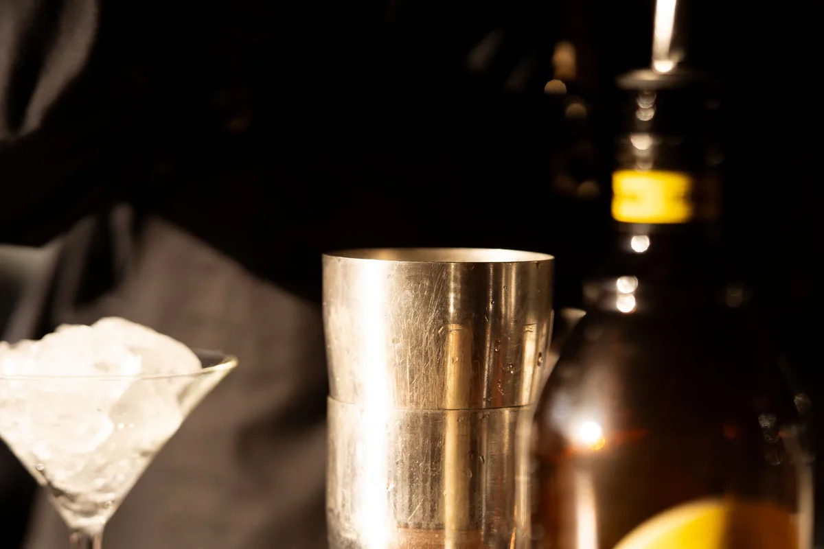 Bartender shaking cocktail ingredients with ice in a cocktail shaker