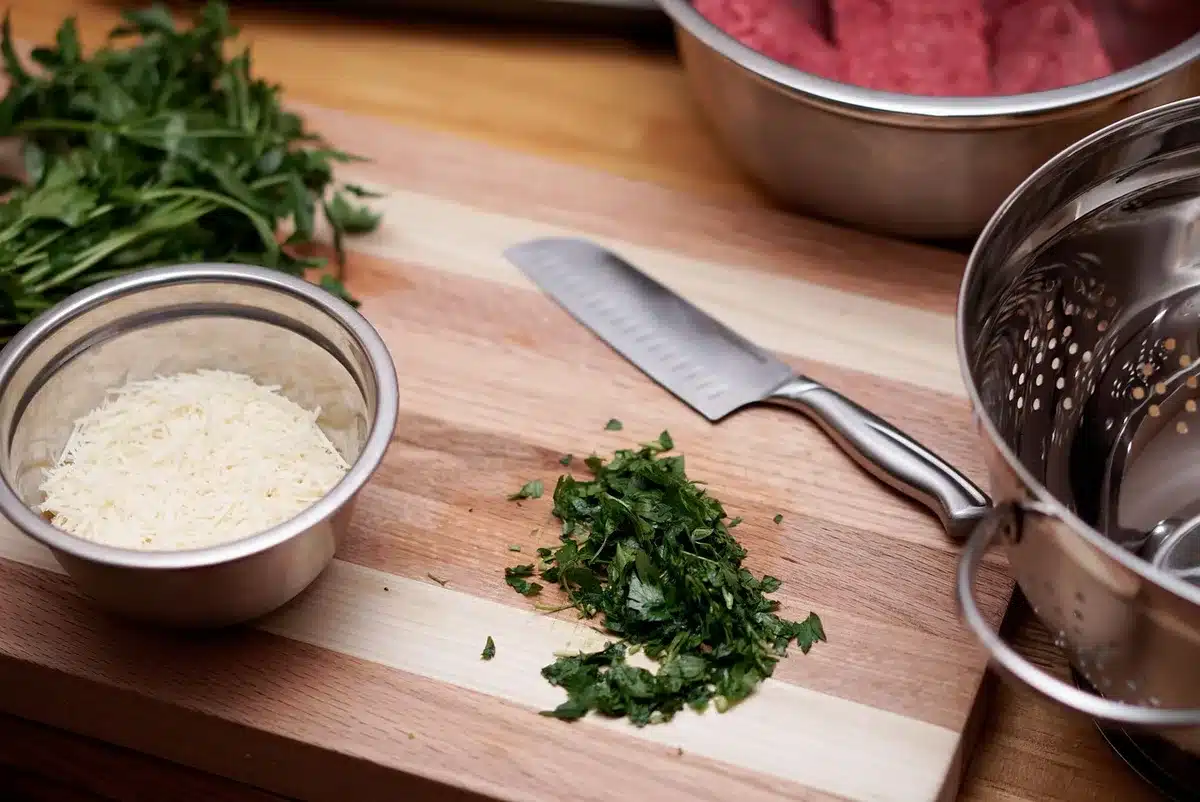 Bowls of ground coriander, cumin and ginger on a wooden board