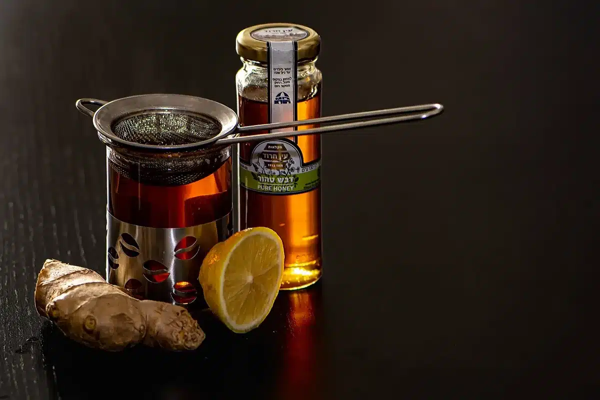 Cocktail with lemon twist and candied ginger on a rocks glass
