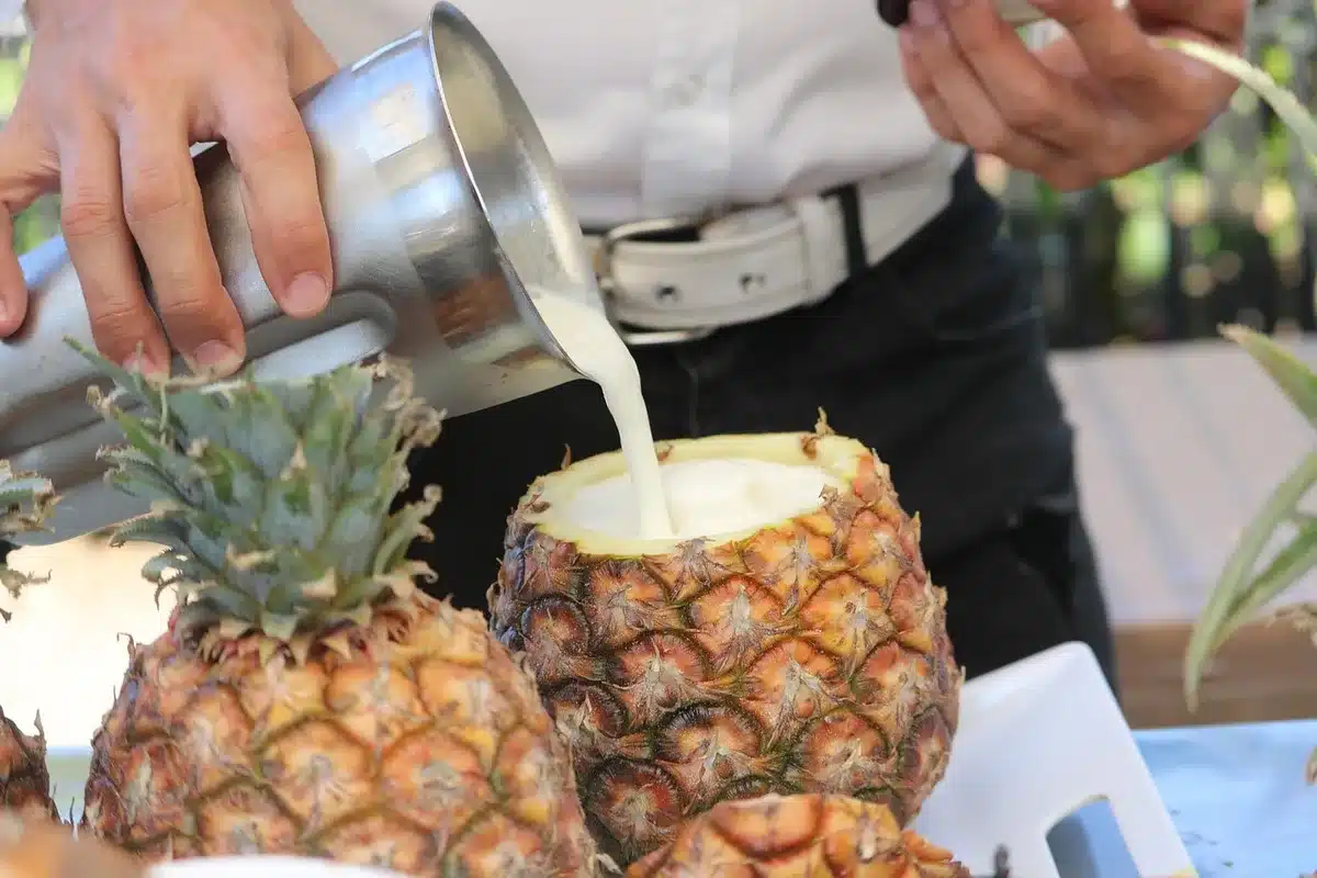 Shaker being strained into a glass over ice for the Veritas gin margarita