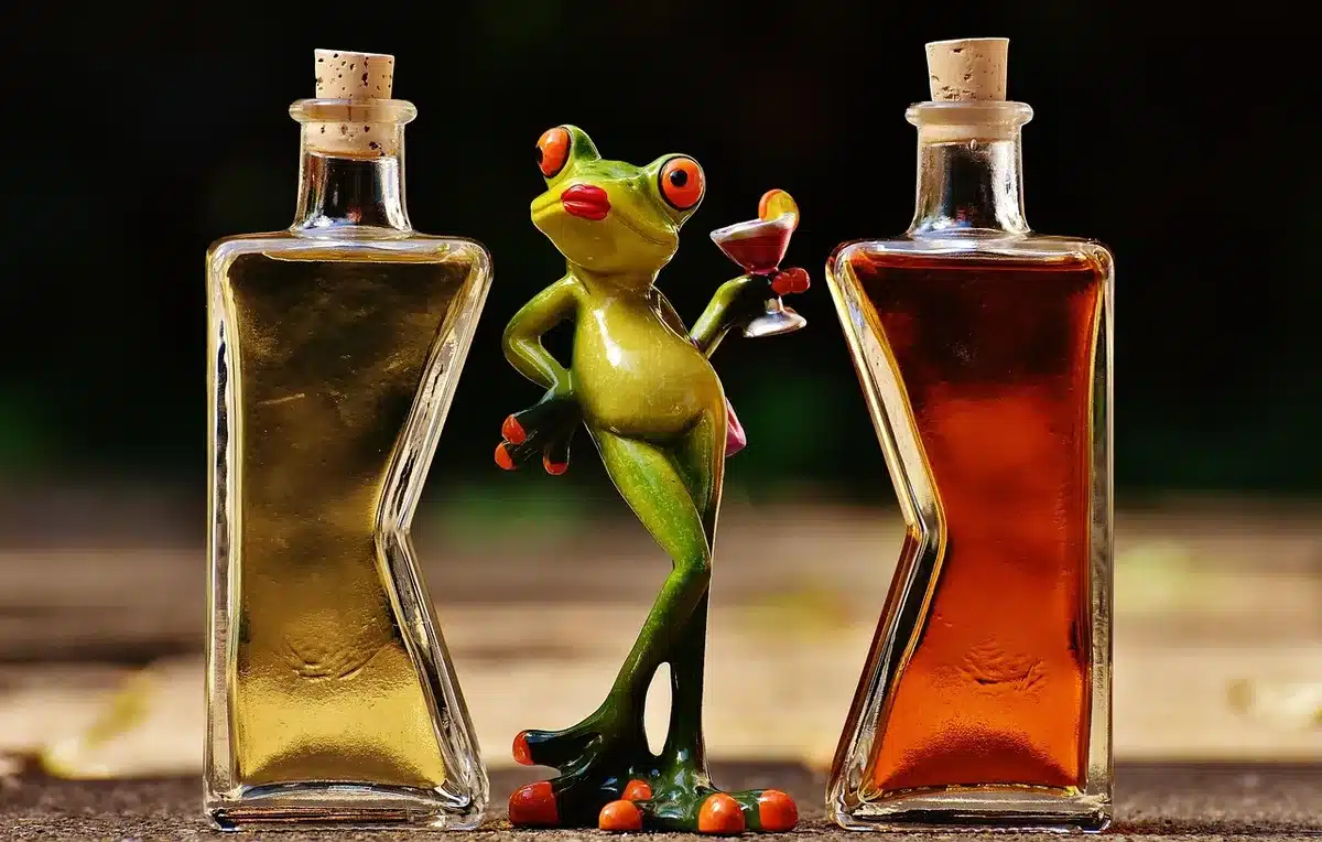 Jigger measuring gin, lime juice and orange liqueur on a bar mat